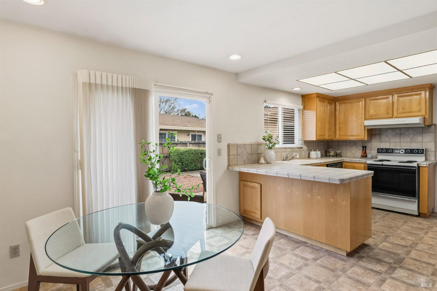 1808 Sherwood Court Santa Rosa, CA 95405 - Photo 13 of 30 a kitchen with a table chairs and a refrigerator