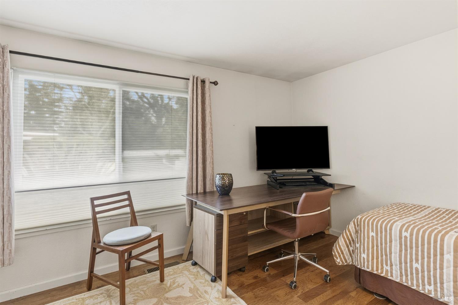 1808 Sherwood Court Santa Rosa, CA 95405 - Photo 26 of 30 a room with a chair and a flat screen tv