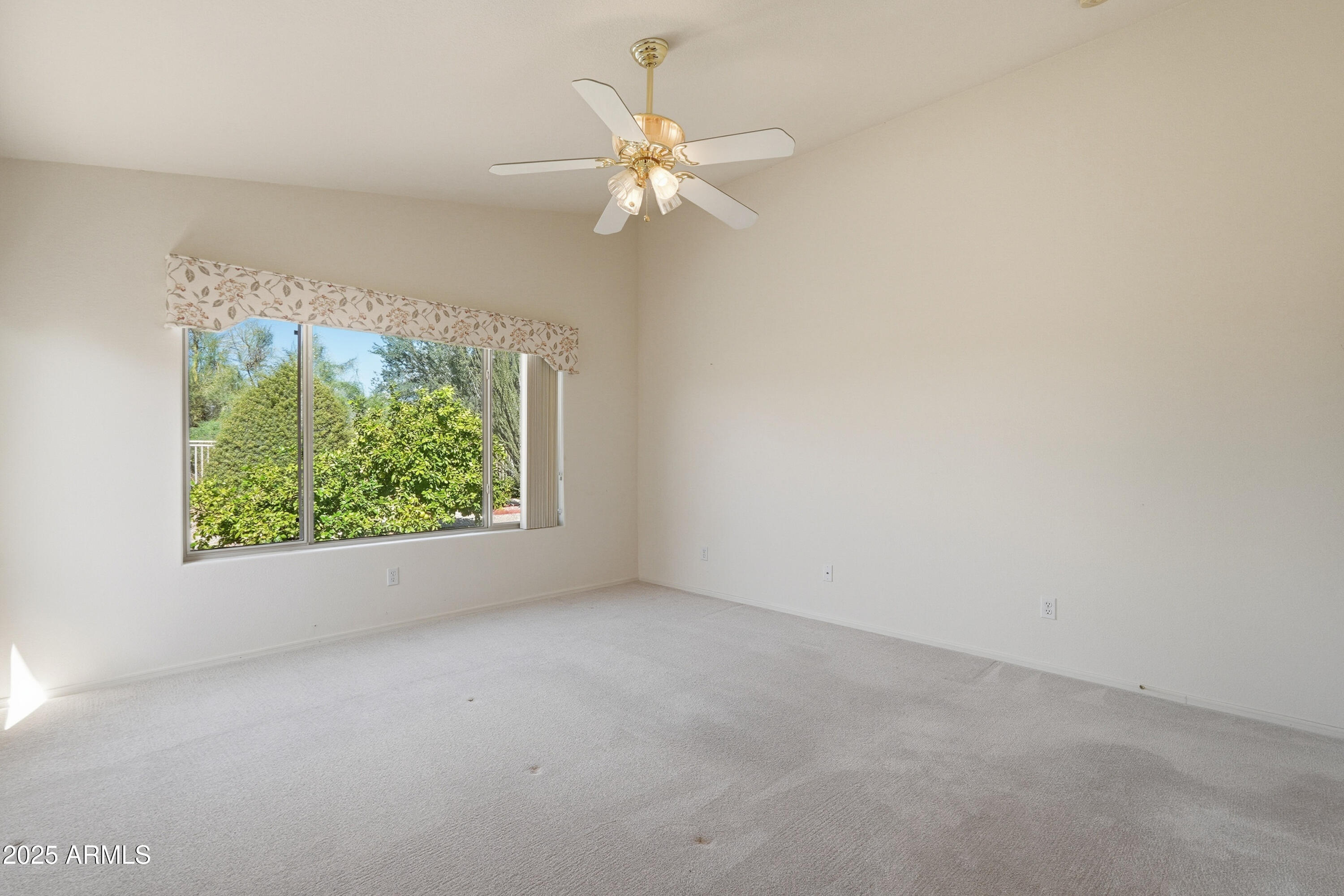 4626 East Thorn Tree Drive Cave Creek, AZ 85331 - Photo 17 of 30 an empty room with a window and a fan