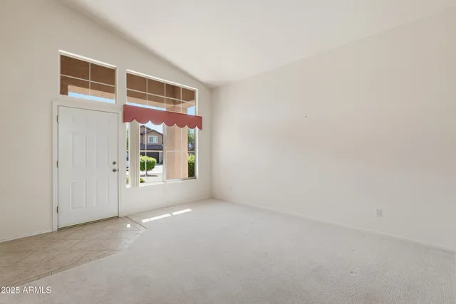 a view of a big room with windows and chandelier