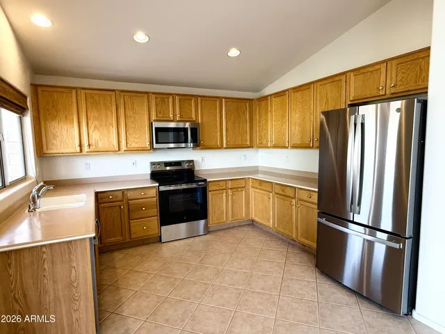 an empty room with a window and a ceiling fan