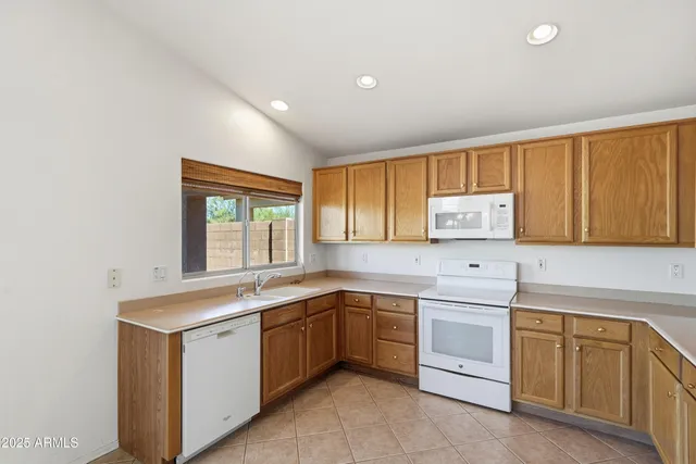 a kitchen with a refrigerator sink and cabinets