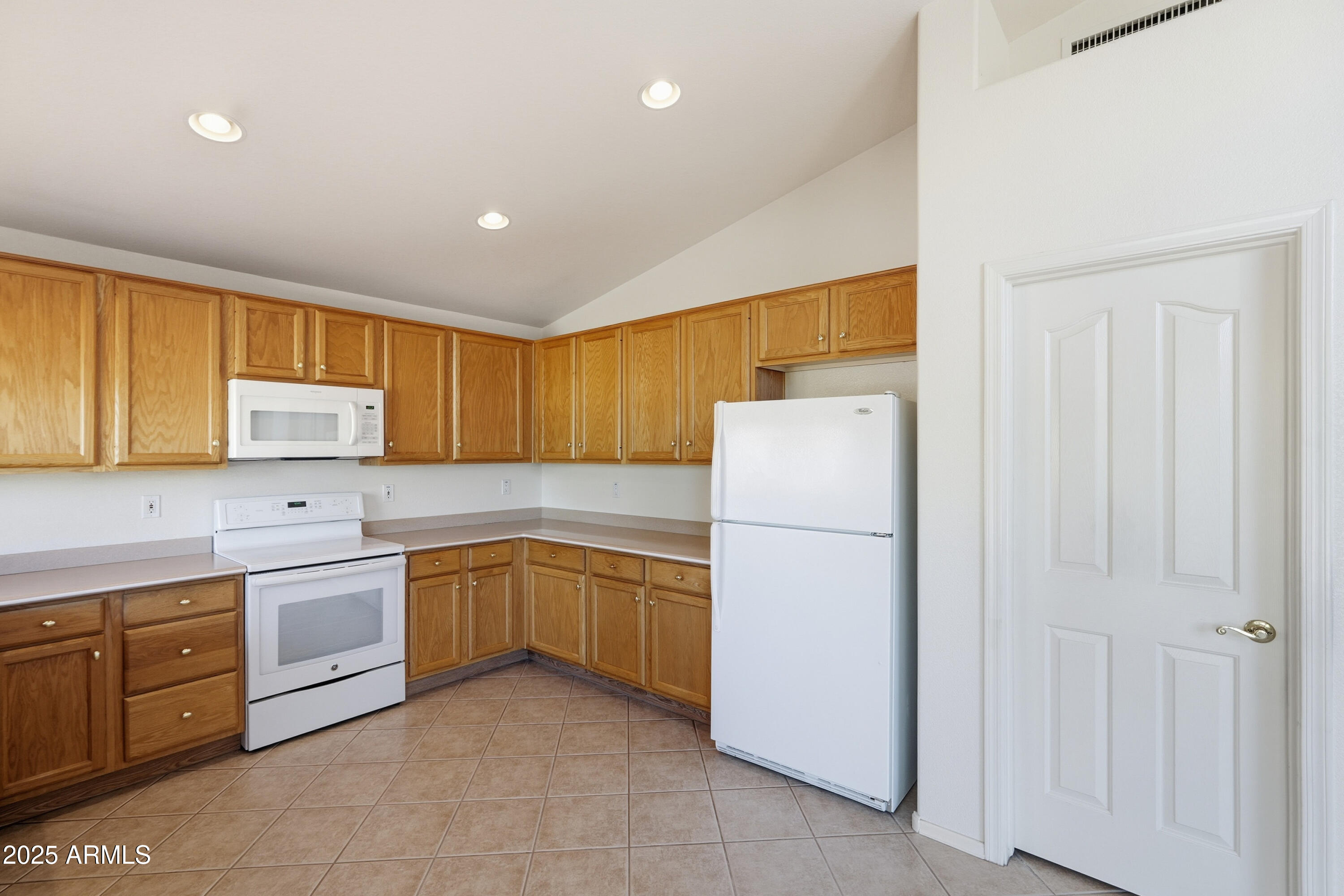 4626 East Thorn Tree Drive Cave Creek, AZ 85331 - Photo 9 of 30 a kitchen with a refrigerator sink and cabinets