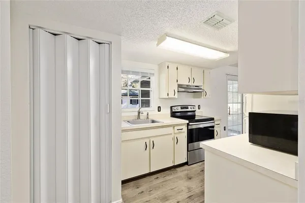a kitchen with stainless steel appliances a sink a stove and a refrigerator
