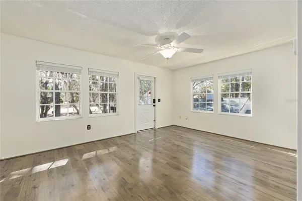 wooden floor in an empty room with a window