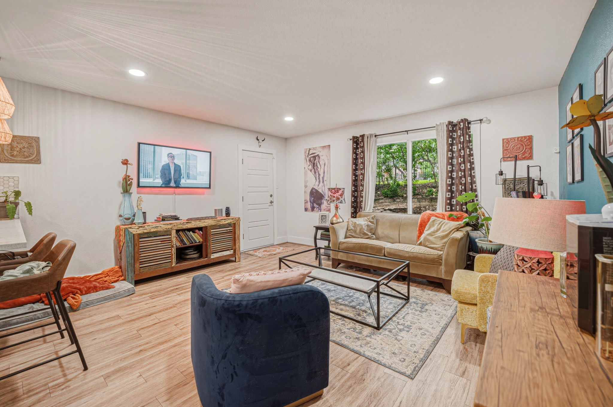 5332 Balcones Drive, Unit B Austin, TX 78731 - Photo 8 of 15 This living space features light wood-style flooring, recessed lighting, and a window providing natural light and views of greenery