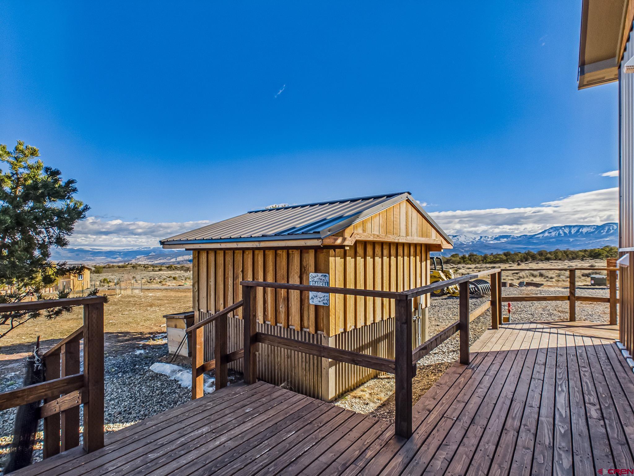 75707 B76 Road Crawford, CO 81415 - Photo 13 of 45 a view of balcony with wooden floor and outdoor seating