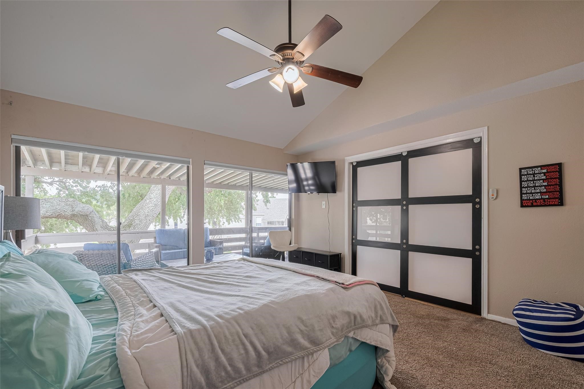 182 April Point Drive North Conroe, TX 77356 - Photo 12 of 17 a bedroom with a large bed and a large window