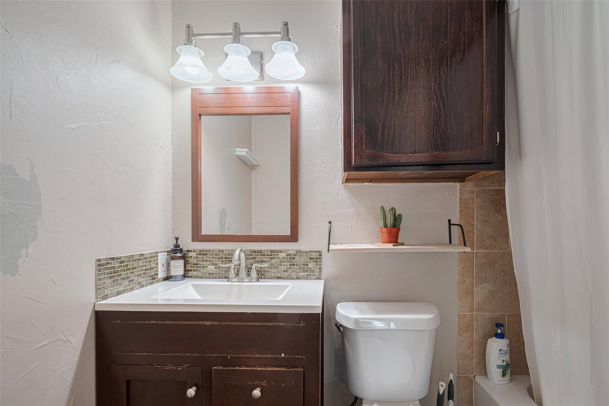 182 April Point Drive North Conroe, TX 77356 - Photo 13 of 17 a bathroom with a toilet sink and mirror