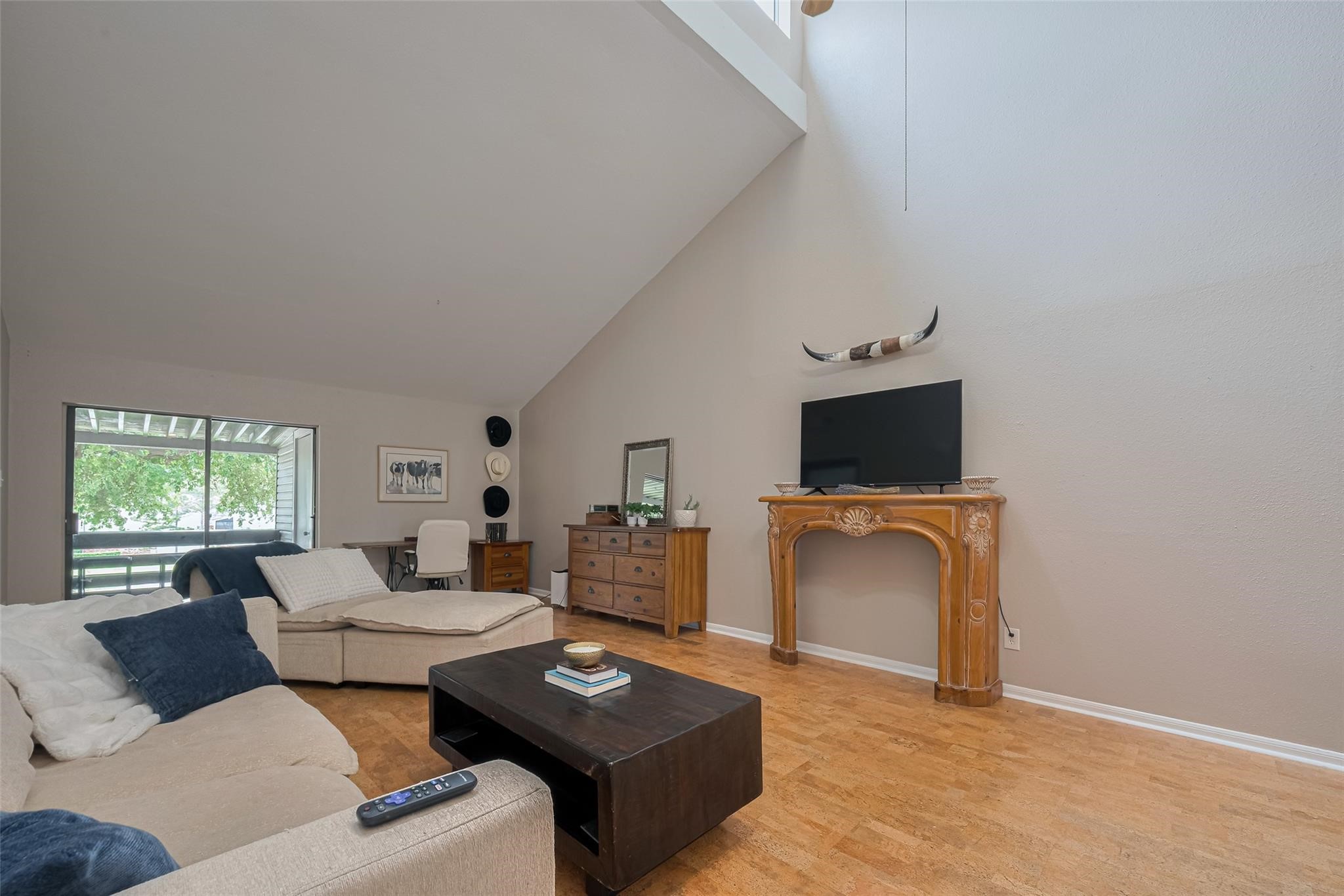 182 April Point Drive North Conroe, TX 77356 - Photo 2 of 17 a living room with furniture a flat screen tv and a window