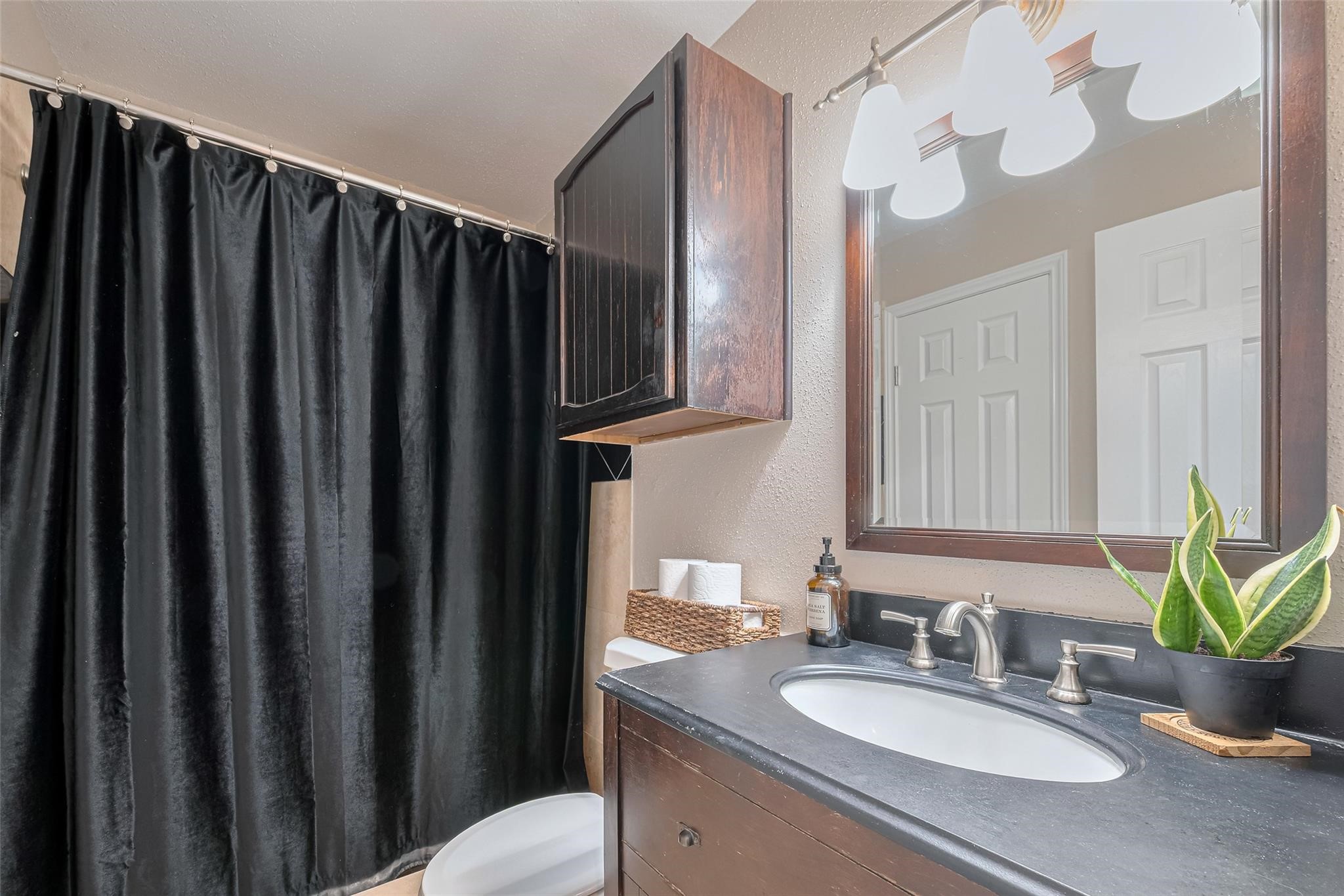 182 April Point Drive North Conroe, TX 77356 - Photo 9 of 17 a bathroom with a granite countertop sink vanity mirror and a bathtub