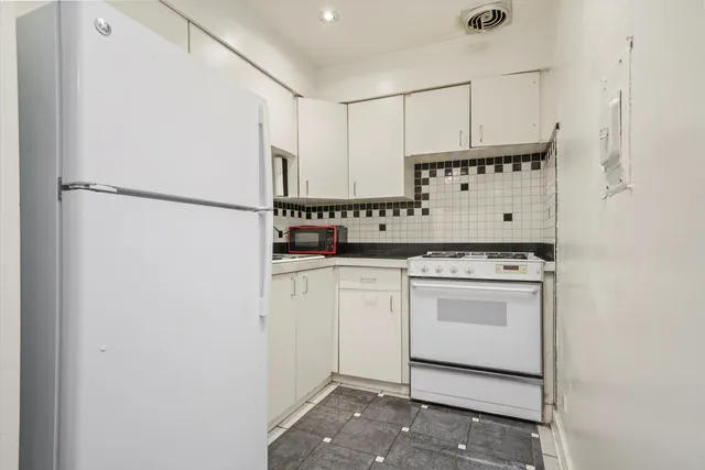 a utility room with cabinets washer and dryer