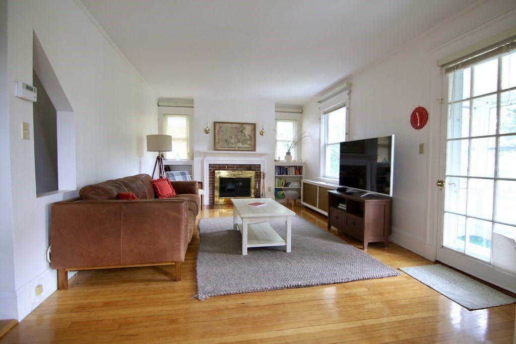 48-50 Townsend Road Belmont, MA 02478 - Photo 11 of 25 a living room with furniture a flat screen tv and a fireplace