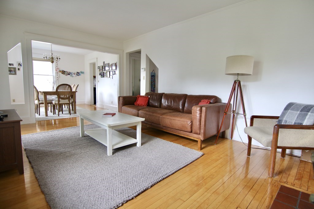 48-50 Townsend Road Belmont, MA 02478 - Photo 12 of 25 a living room with furniture a dining table and a wooden floor