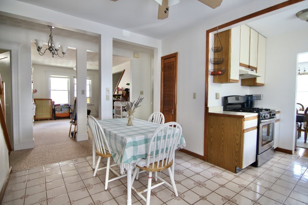 48-50 Townsend Road Belmont, MA 02478 - Photo 15 of 25 a dining room with stainless steel appliances kitchen island granite countertop a table and chairs in it