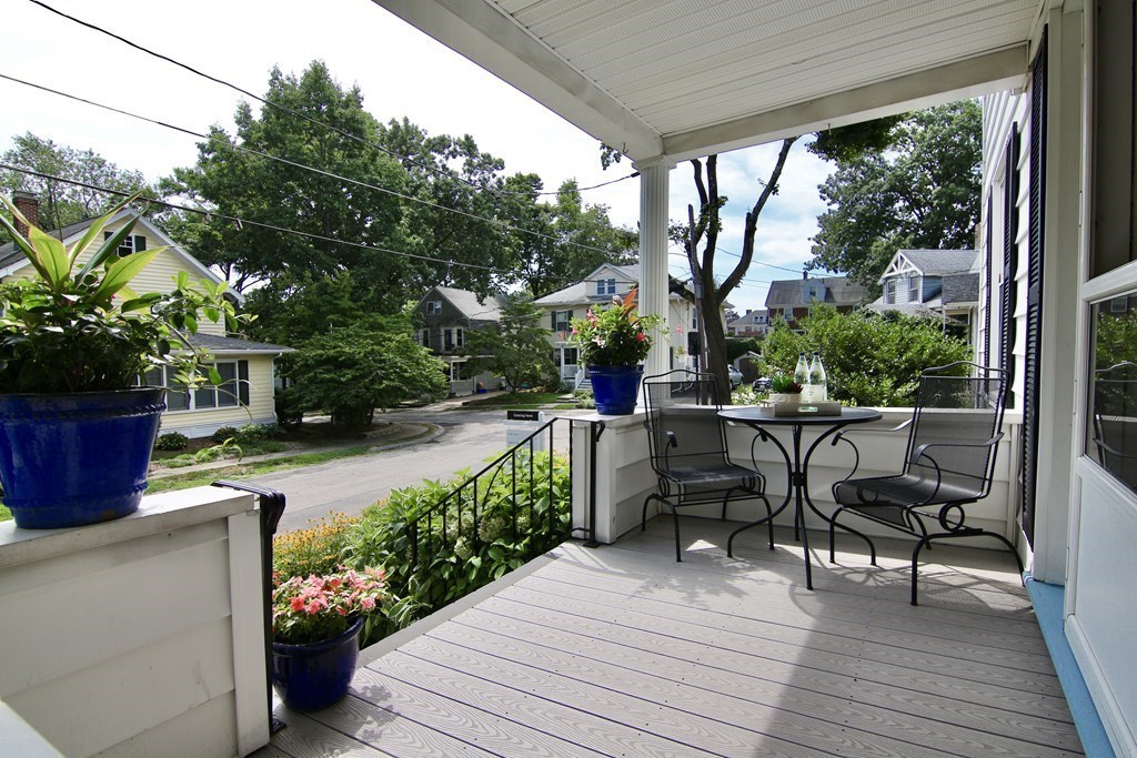48-50 Townsend Road Belmont, MA 02478 - Photo 2 of 25 a view of a patio with table and chairs potted plants with wooden floor