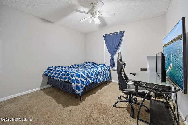 a bedroom with bed and a chandelier