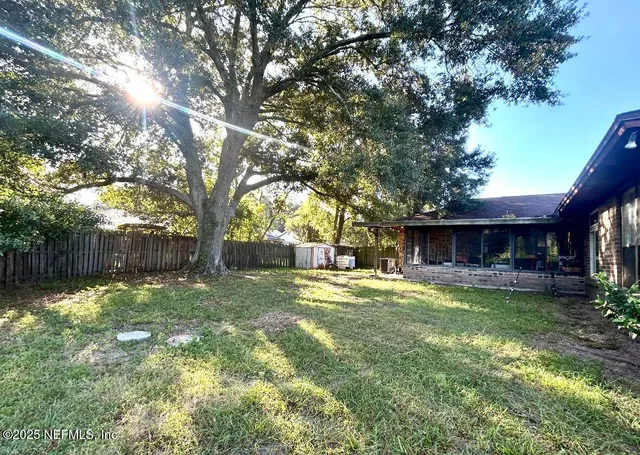 a house view with a sitting space and a tree