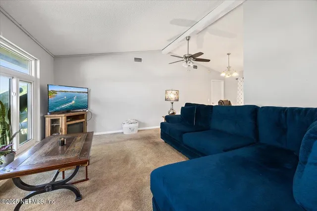 a living room with furniture a fireplace and a table