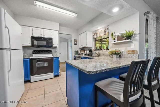 a kitchen with a stove a sink and a refrigerator
