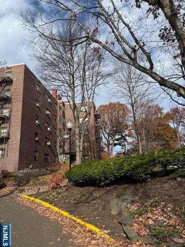 a kitchen with white cabinets and black appliances