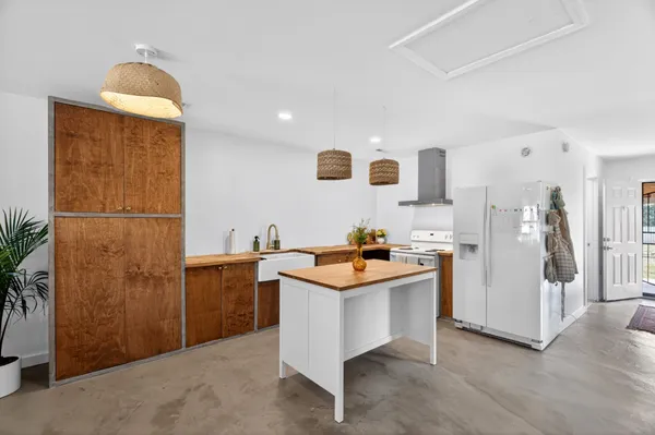 a kitchen with stainless steel appliances granite countertop a refrigerator and a sink
