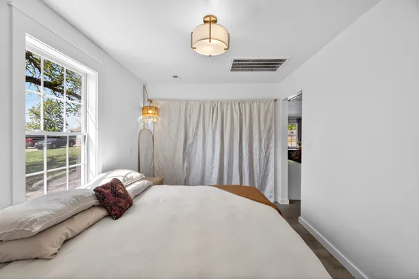 a bedroom with a bed and window