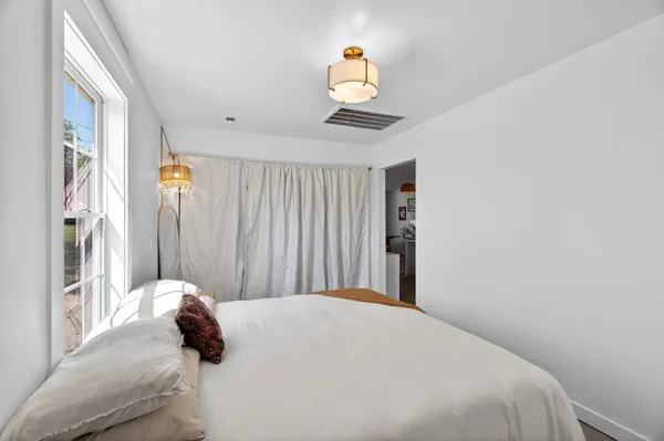 a bedroom with a bed and a window
