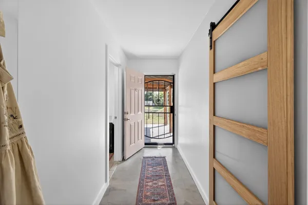 a view of hallway with wooden floor