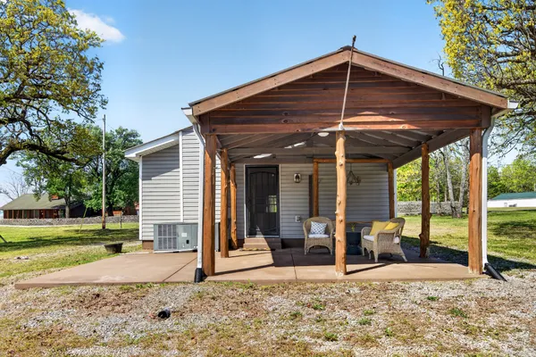 a view of a house with backyard and a patio
