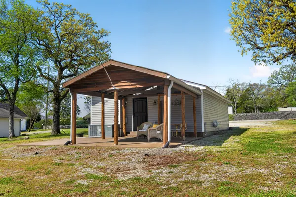 a view of a house with backyard porch and sitting area
