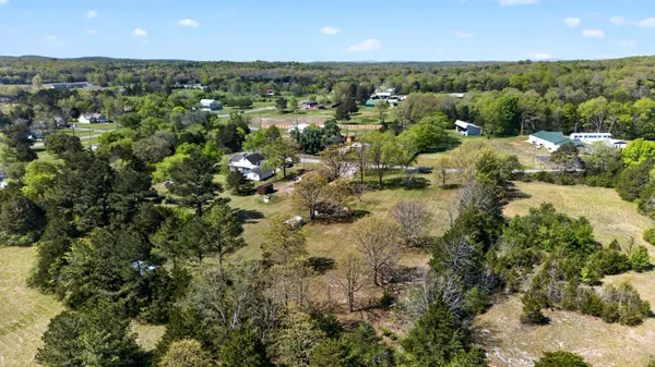 an aerial view of a houses with a yard