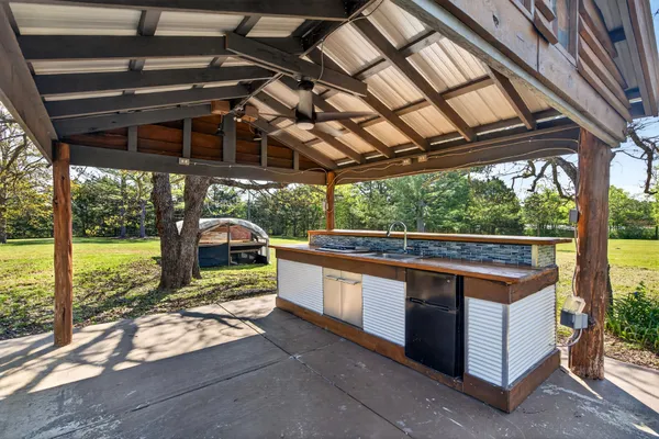 a view of a porch with furniture and a yard