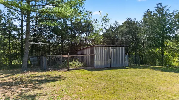 a view of a backyard with a small cabin