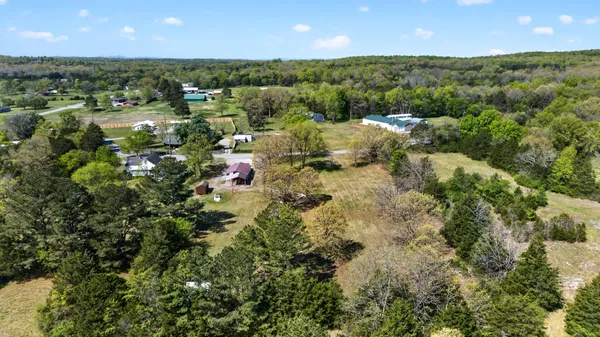 an aerial view of a houses with a yard
