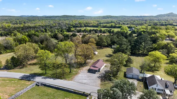 an aerial view of house with yard swimming pool and mountains