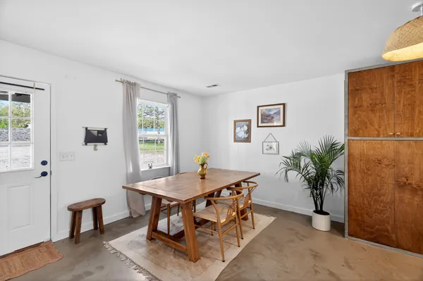 a dining room with furniture and window