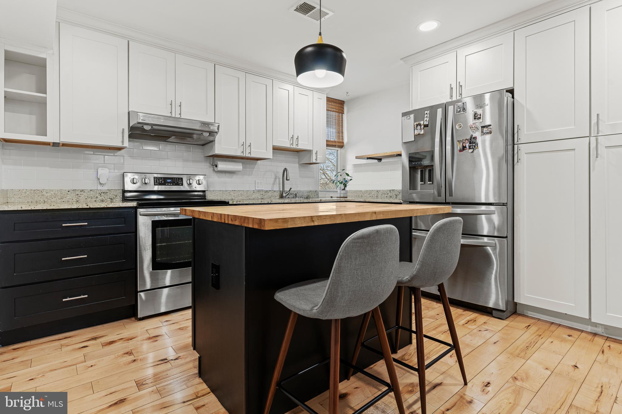 2361 Sundew Terrace, Unit 2361 Baltimore, MD 21209 - Photo 1 of 25 a kitchen with stainless steel appliances granite countertop a stove a refrigerator a sink a dining table and chairs