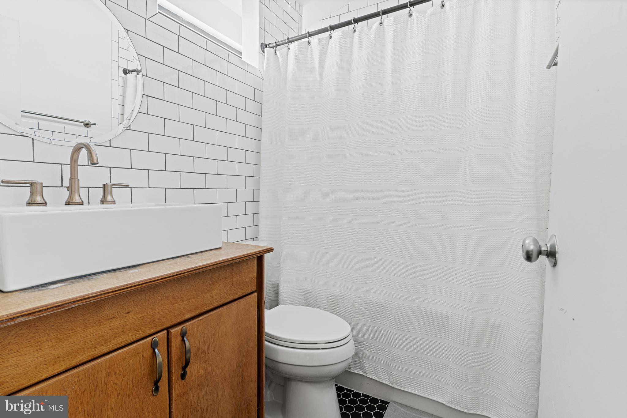 2361 Sundew Terrace, Unit 2361 Baltimore, MD 21209 - Photo 20 of 25 a bathroom with a sink a toilet and shower