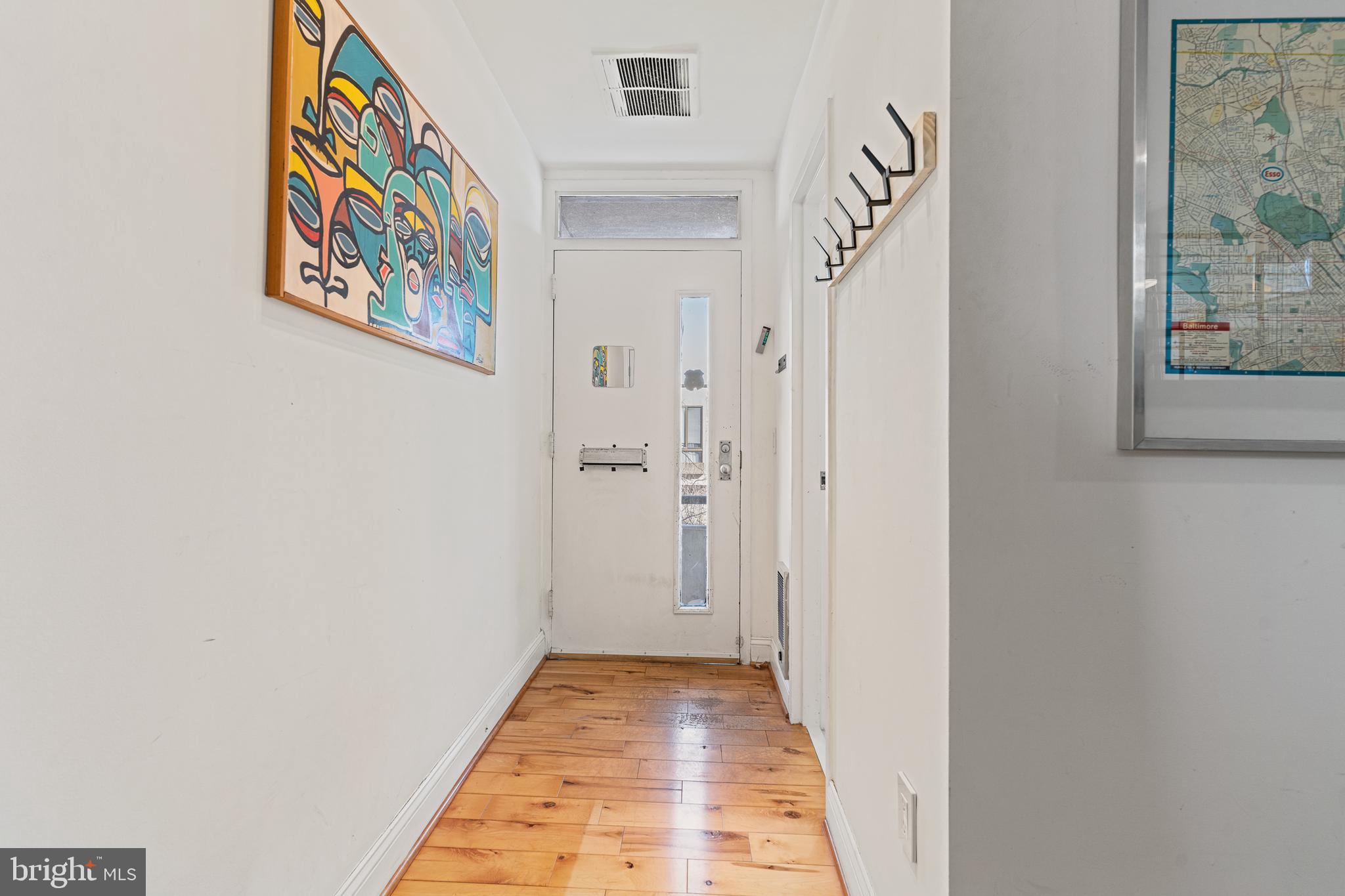 2361 Sundew Terrace, Unit 2361 Baltimore, MD 21209 - Photo 4 of 25 a view of a hallway with paintings on the wall