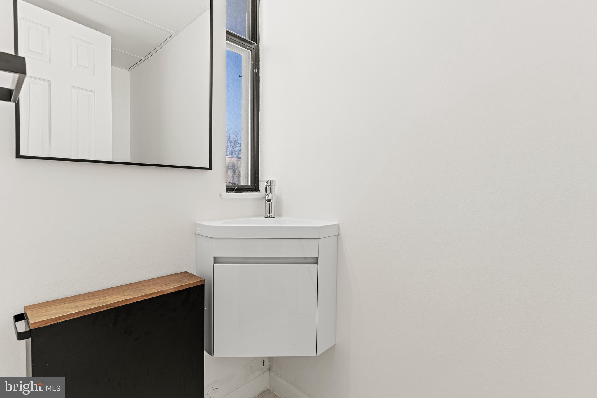 2361 Sundew Terrace, Unit 2361 Baltimore, MD 21209 - Photo 5 of 25 a bathroom with a sink and a mirror