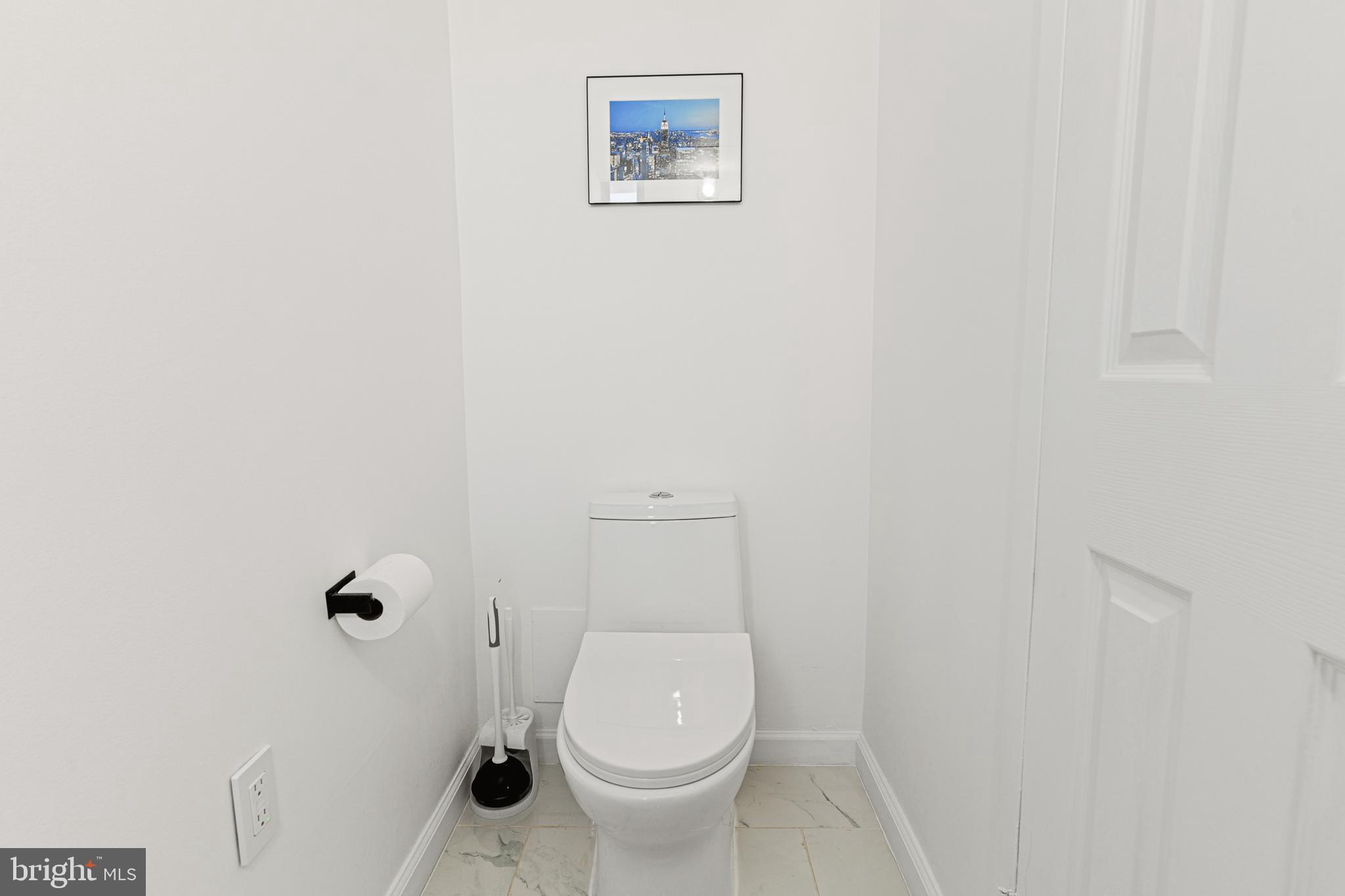 2361 Sundew Terrace, Unit 2361 Baltimore, MD 21209 - Photo 6 of 25 a white toilet sitting next to a white wall