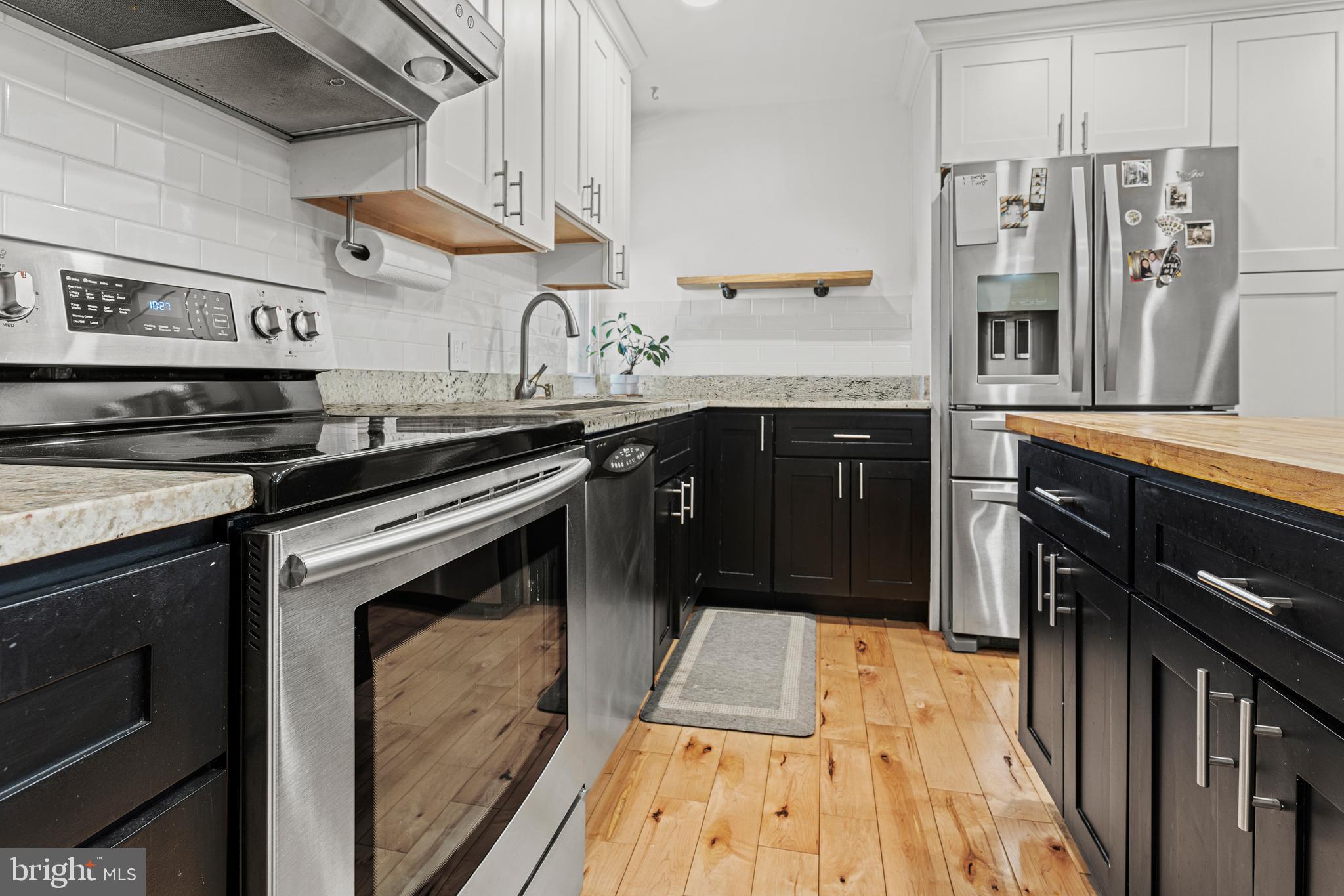 2361 Sundew Terrace, Unit 2361 Baltimore, MD 21209 - Photo 8 of 25 a kitchen with stainless steel appliances granite countertop a stove and a refrigerator