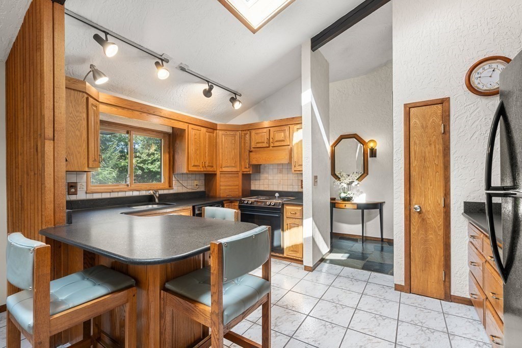 22 Maple Avenue Boxford, MA 01921 - Photo 11 of 42 a kitchen with a dining table chairs and refrigerator