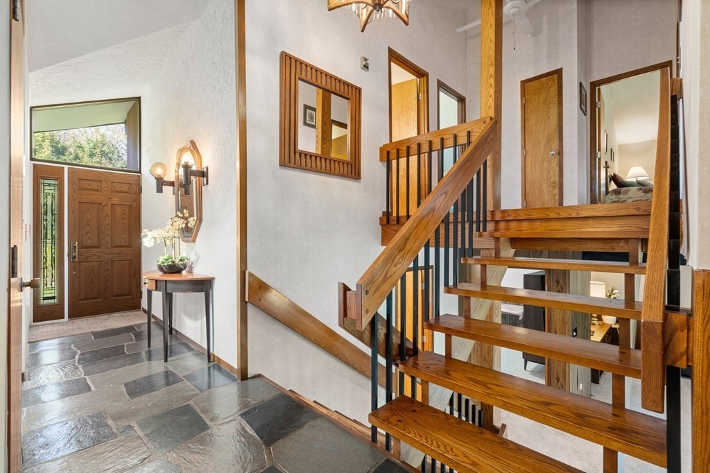 22 Maple Avenue Boxford, MA 01921 - Photo 2 of 42 a view of staircase with lots of frames on wall and a window