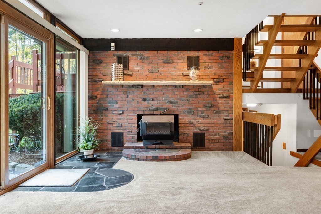 22 Maple Avenue Boxford, MA 01921 - Photo 23 of 42 a living room with furniture and a fireplace