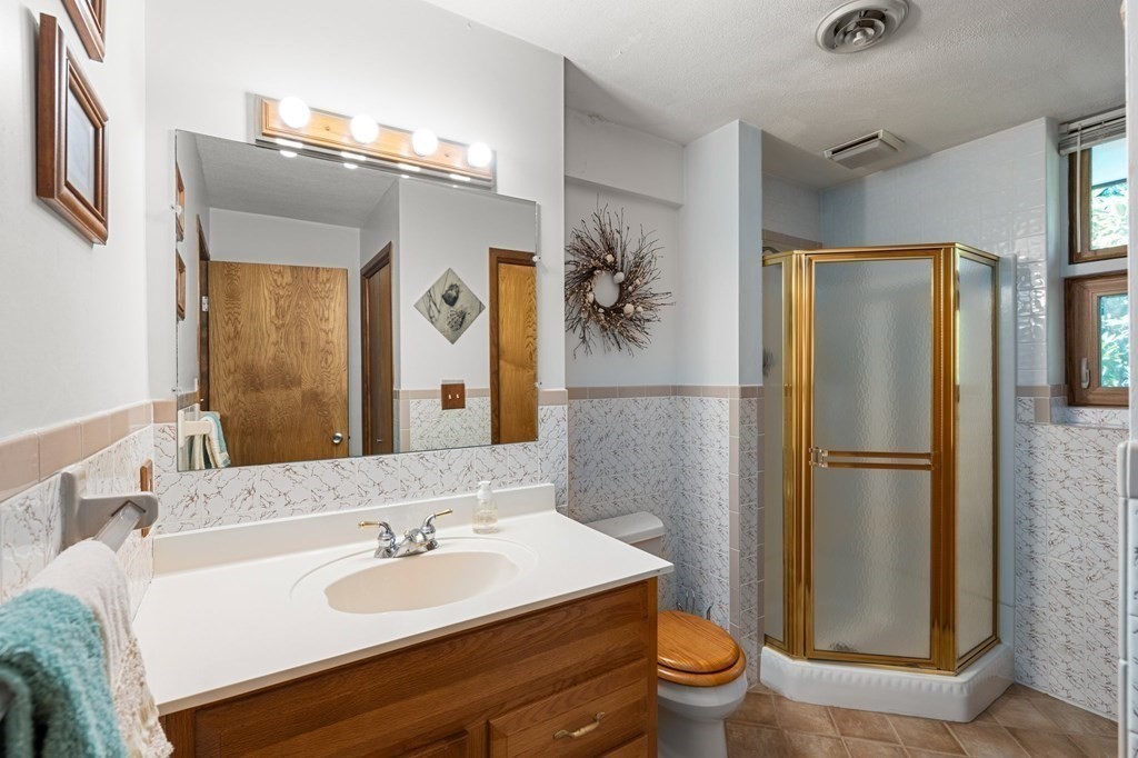 22 Maple Avenue Boxford, MA 01921 - Photo 29 of 42 a bathroom with a sink a toilet and a mirror
