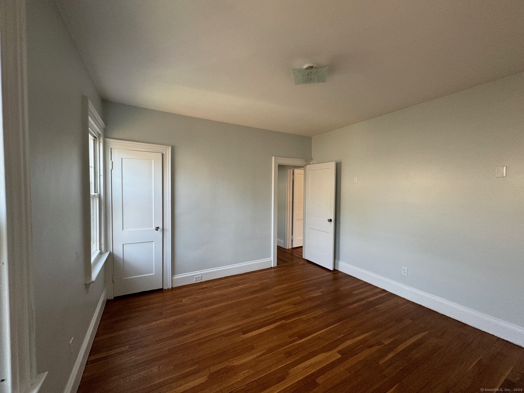 1253 Forest Road, Unit 2 New Haven, CT 06515 - Photo 25 of 30 a view of an empty room with wooden floor and closet