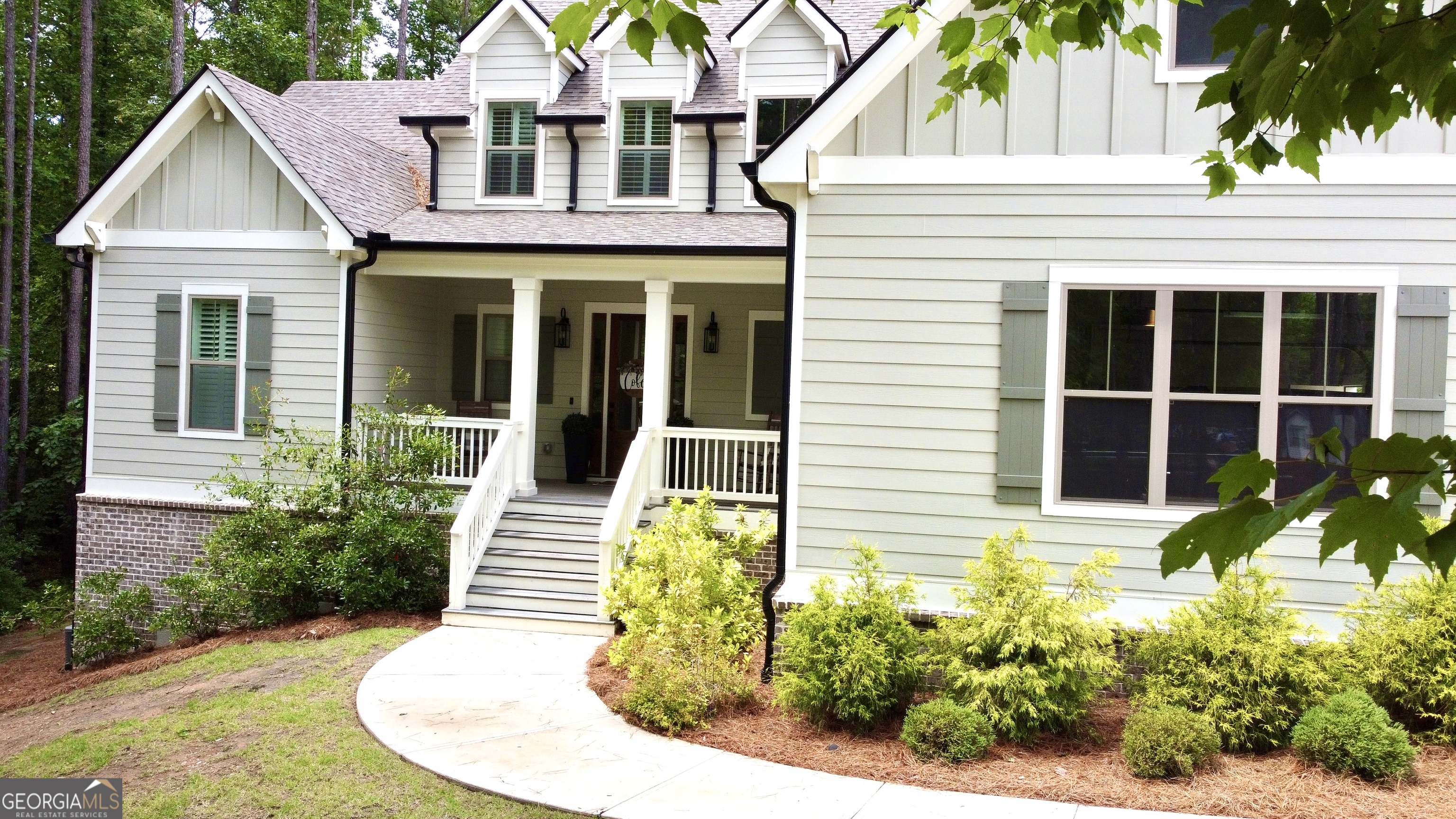 120 Spring Creek Drive Rutledge, GA 30663 - Photo 2 of 38 a front view of a house with a yard and potted plants