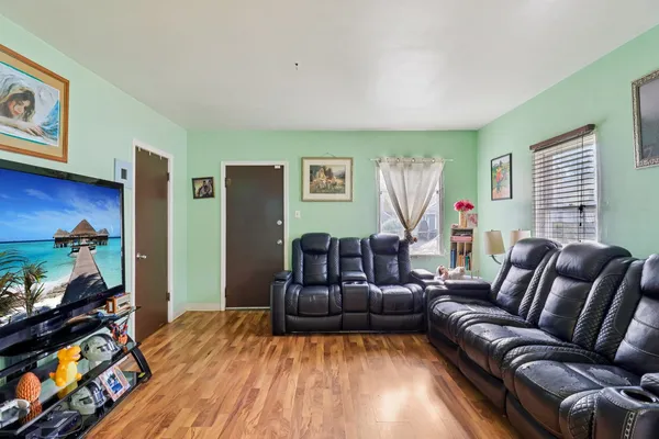 a living room with furniture and a flat screen tv